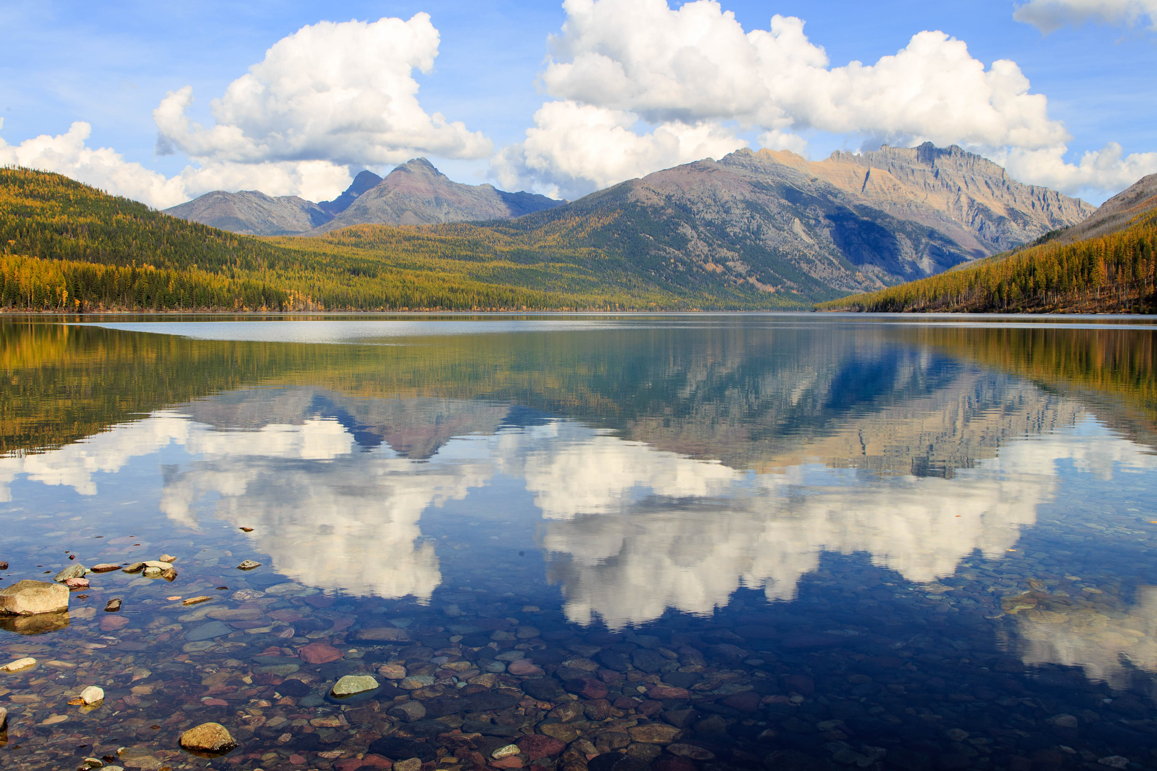 western montana mountains reflected in body of water