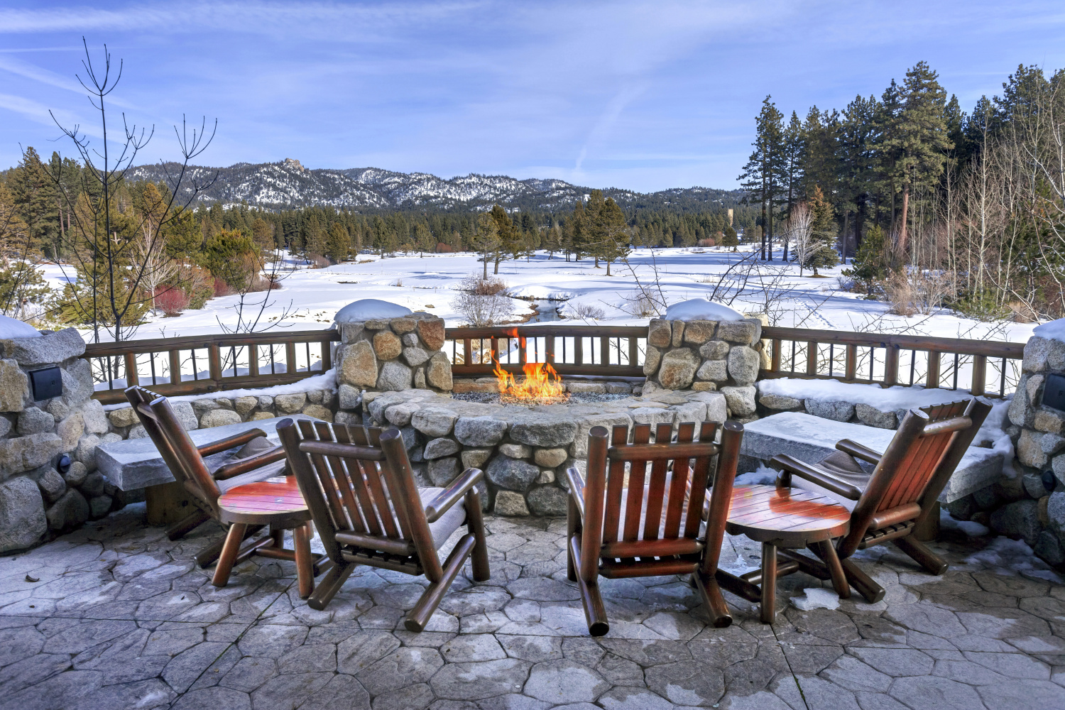 chairs placed around an outdoor fire pit with a view of the forest near Tahoe