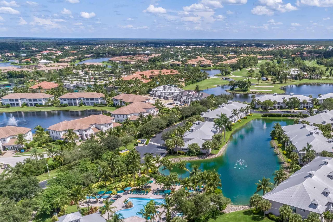 aerial view of homes, palm trees, golf courses, and manmade lakes in Naples