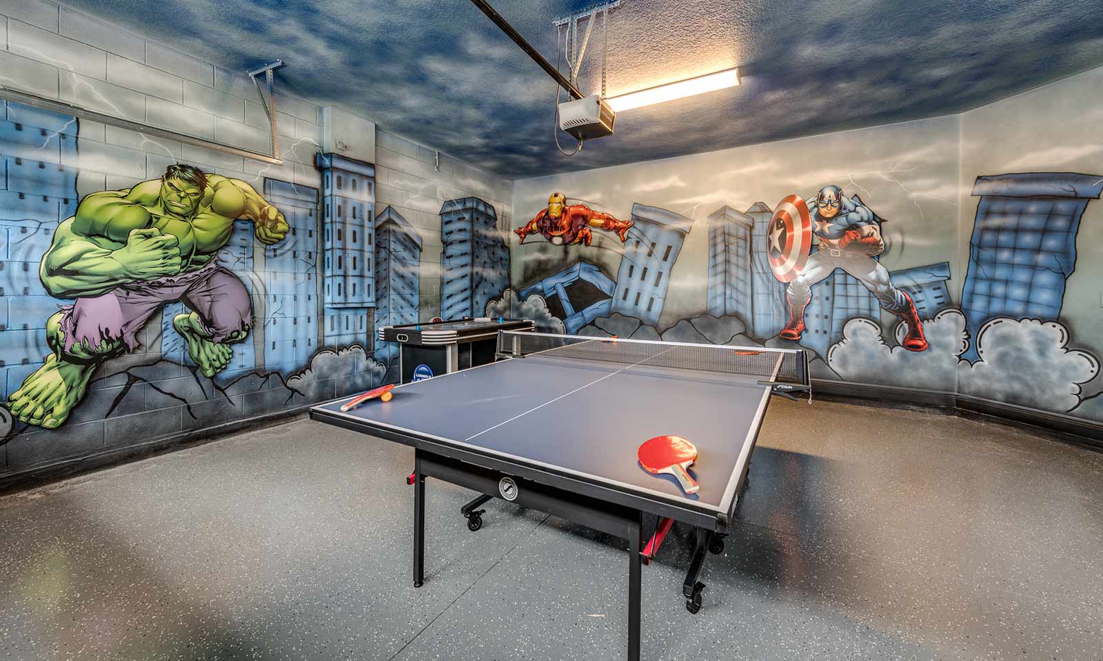 A Marvel themed game room with a ping pong table at a vacation rental in Florida near Disney World.