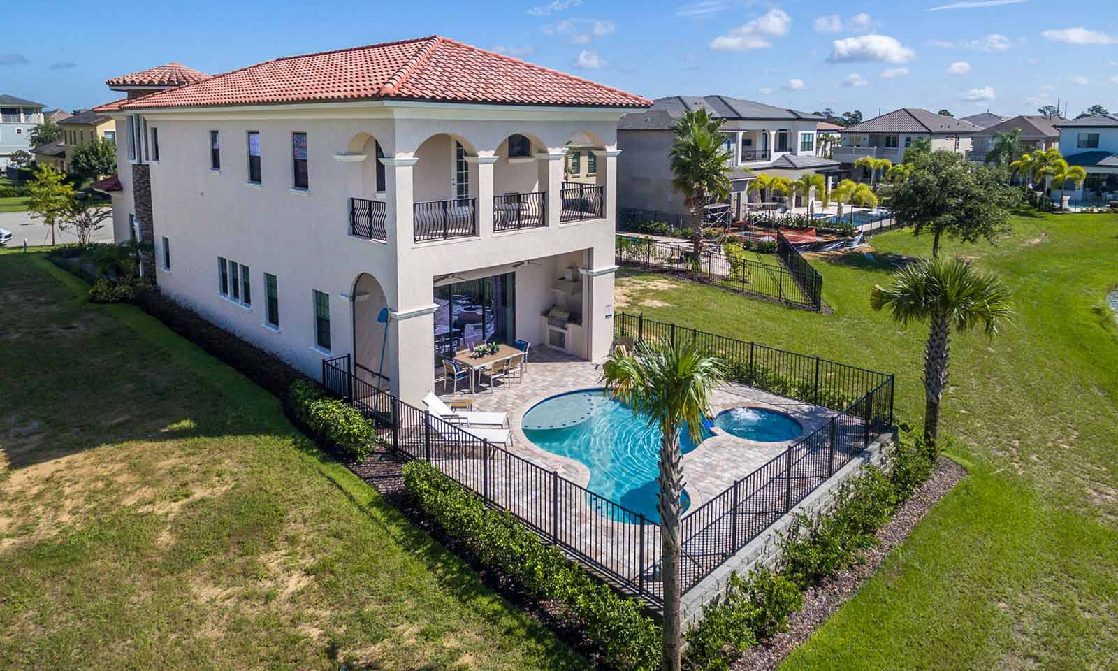 vacation home near disney with mickey mouse shaped pool, patio, and top floor balcony
