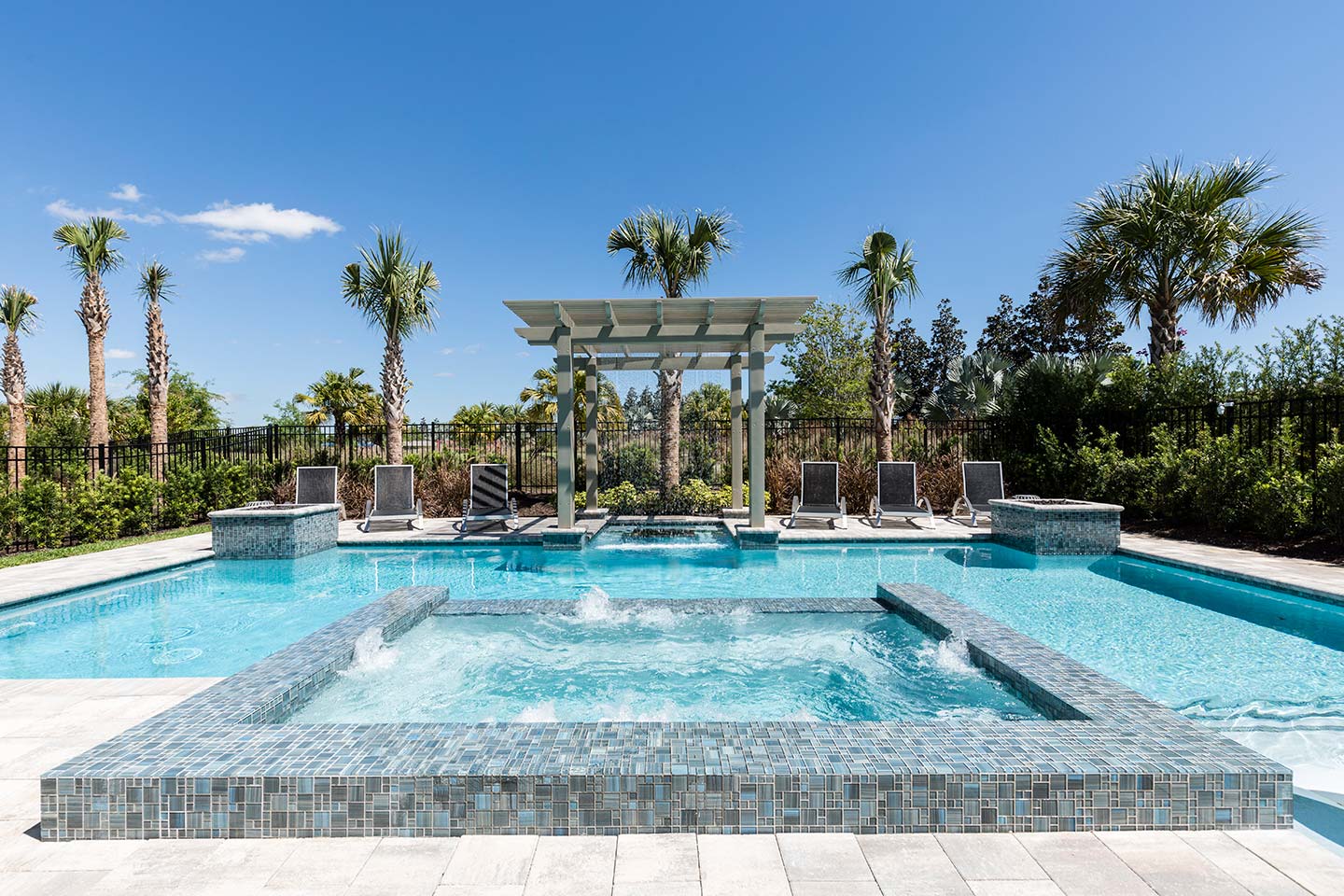 The pool area with a jacuzzi at a vacation rental in Florida.
