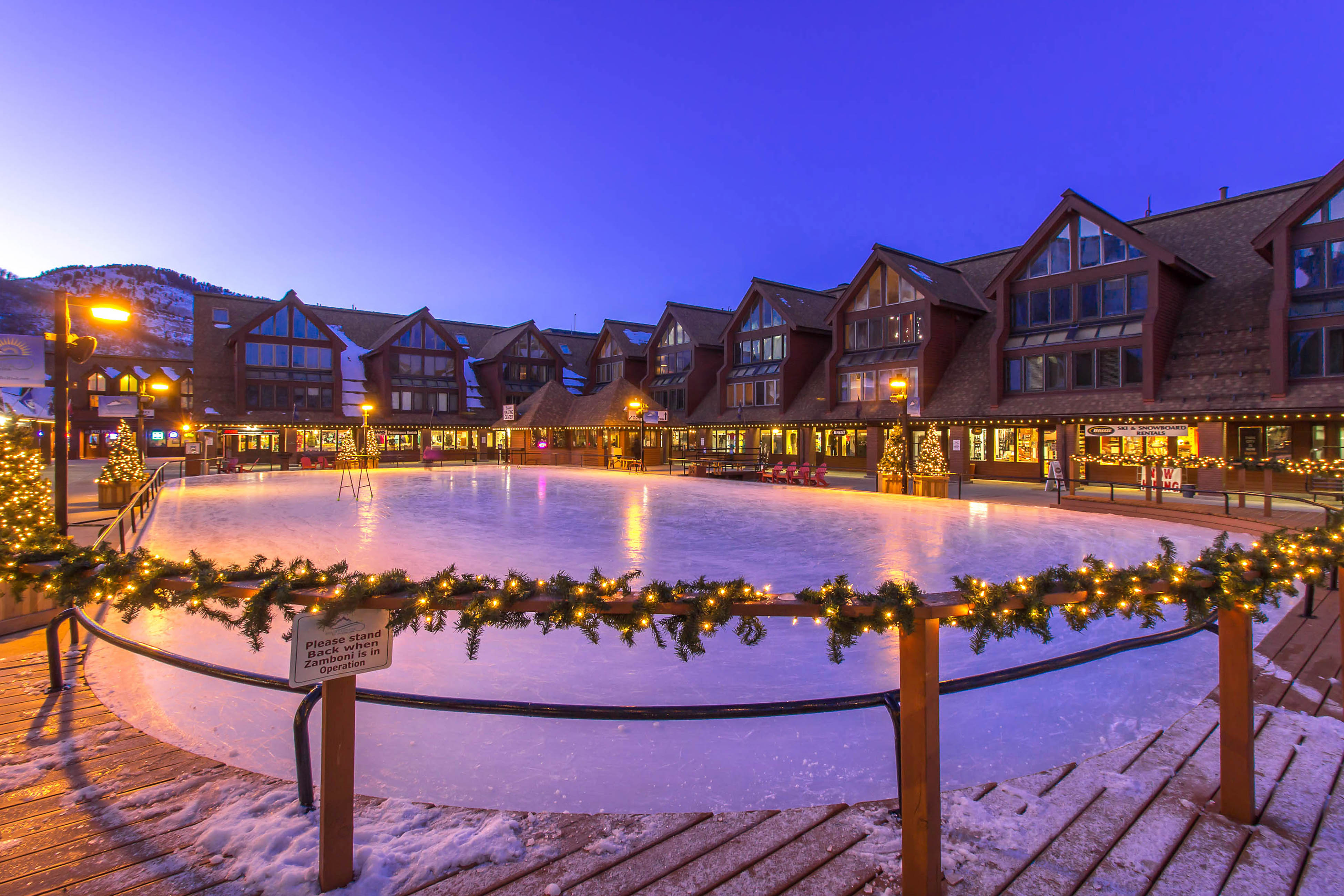Night time view of the lit up ice skating rink in Park City, Utah