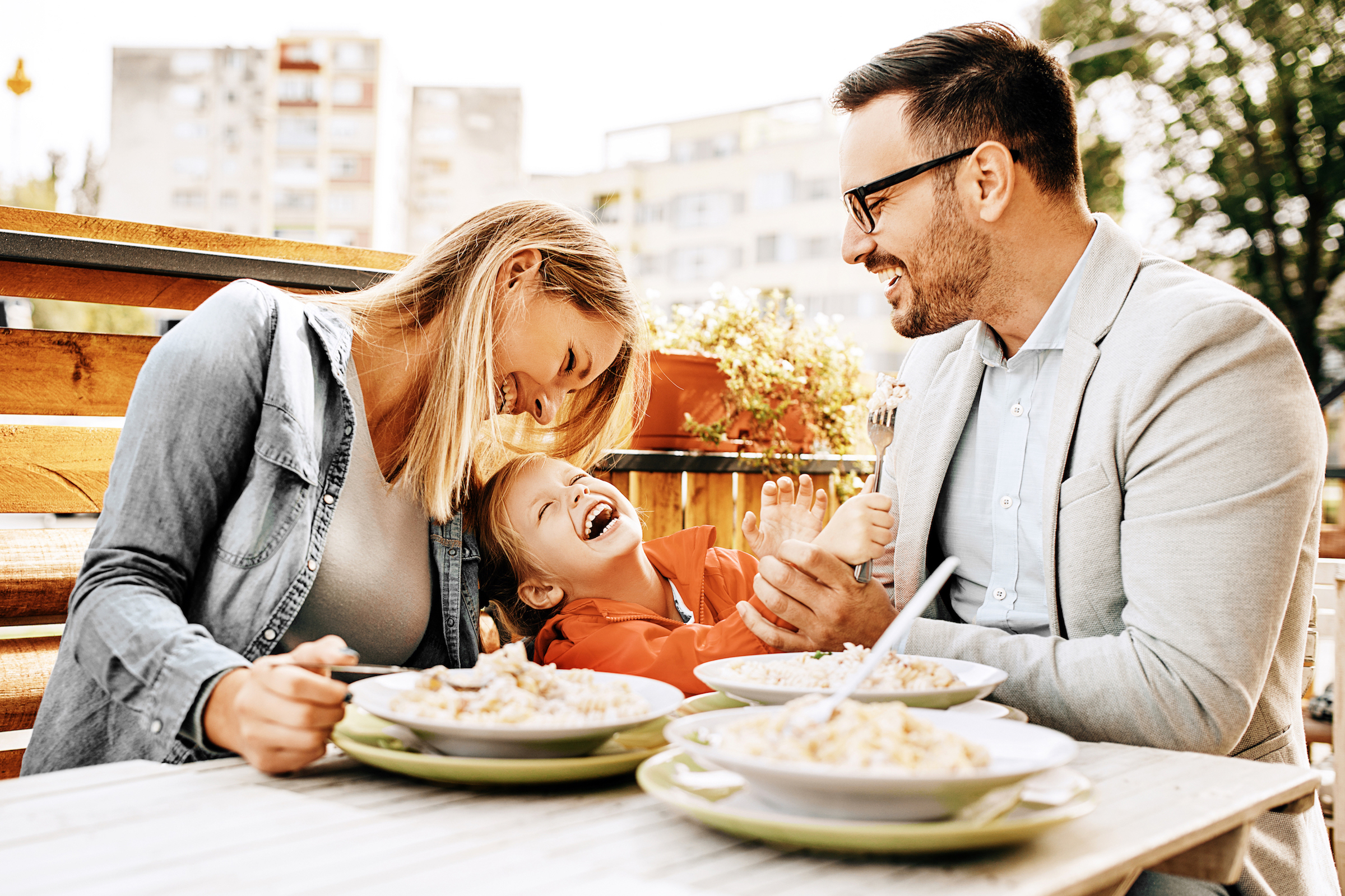 Family laughing and enjoying a meal