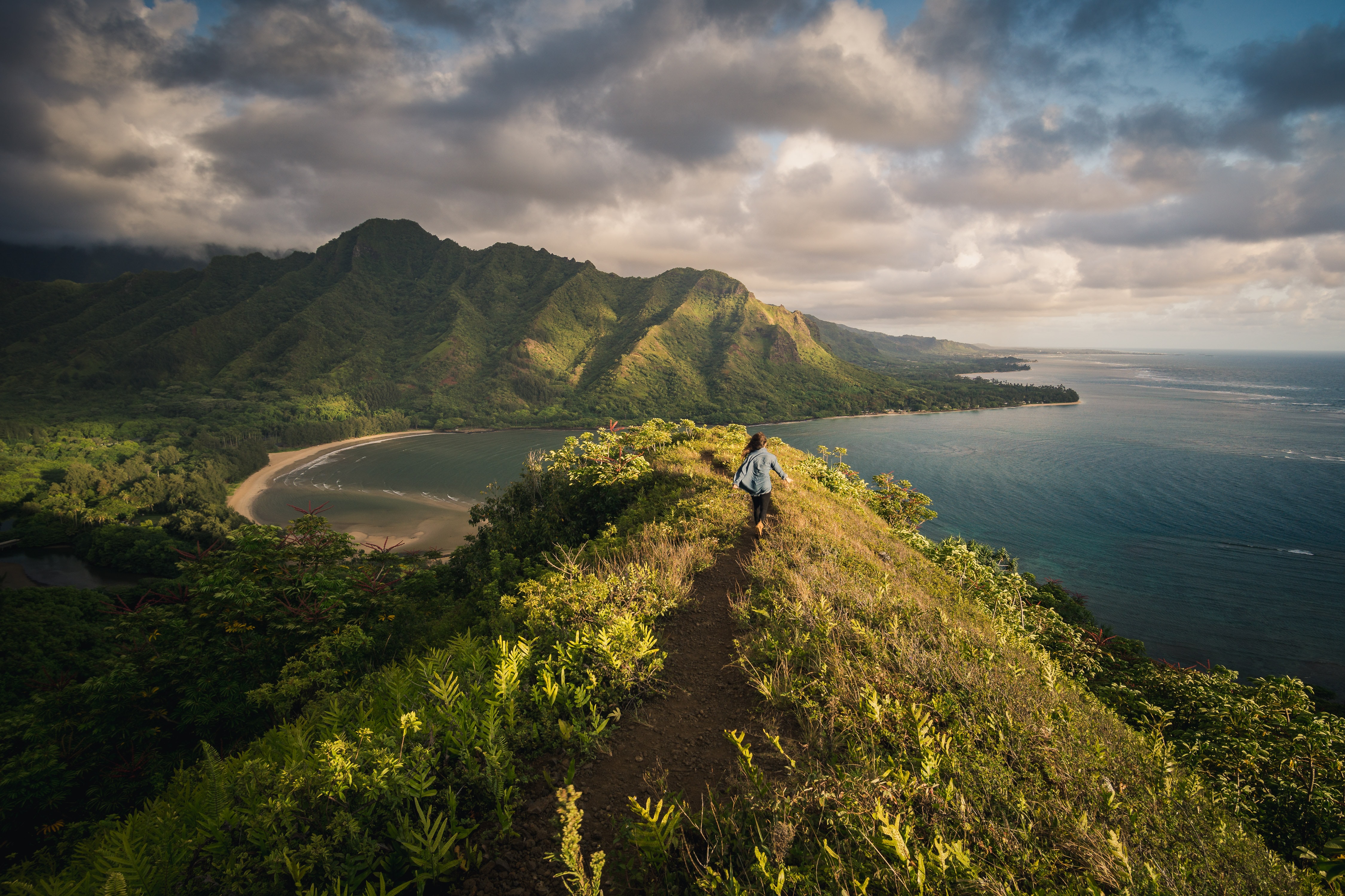 Woman hiking up to a peak in Hawaii