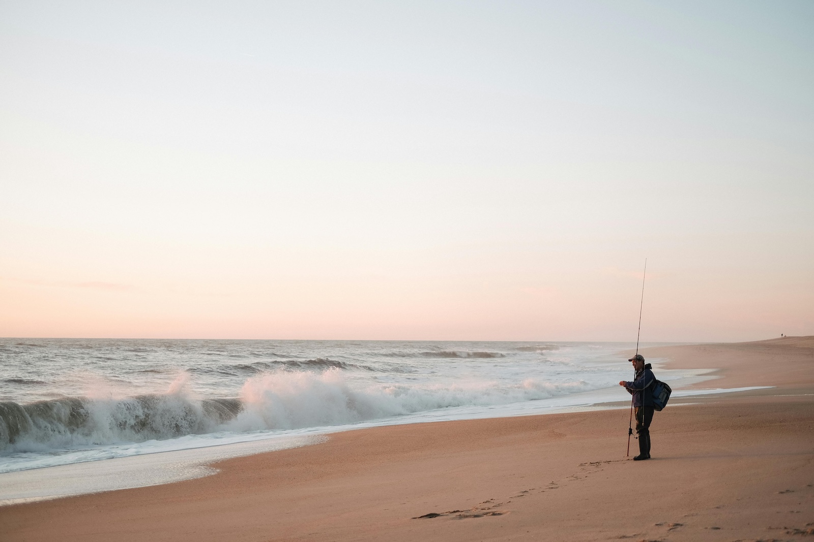 Man on a beach fishing in Alabama.