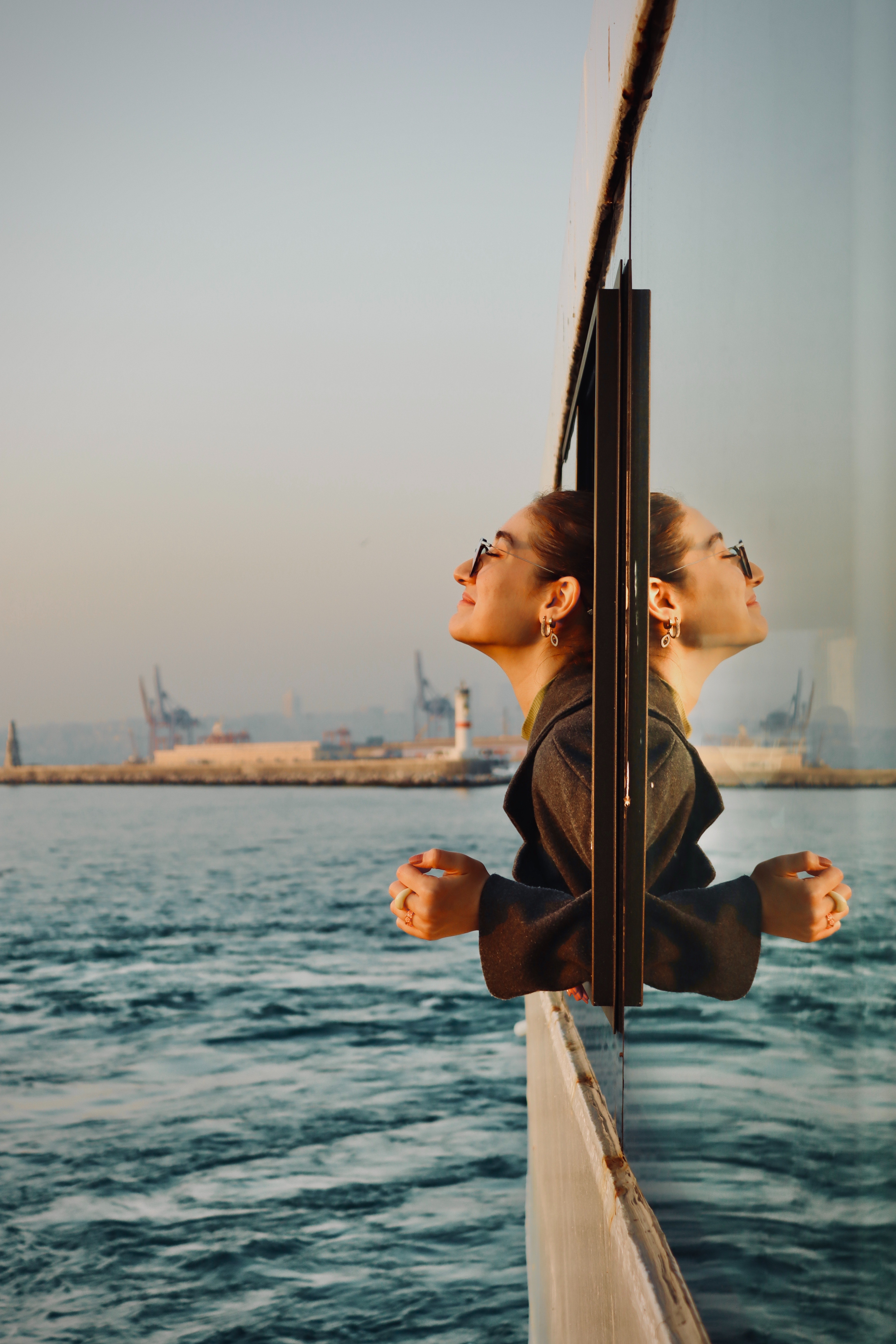 Woman leaning outside of a boat catching fresh air during a teacher travel excursion.