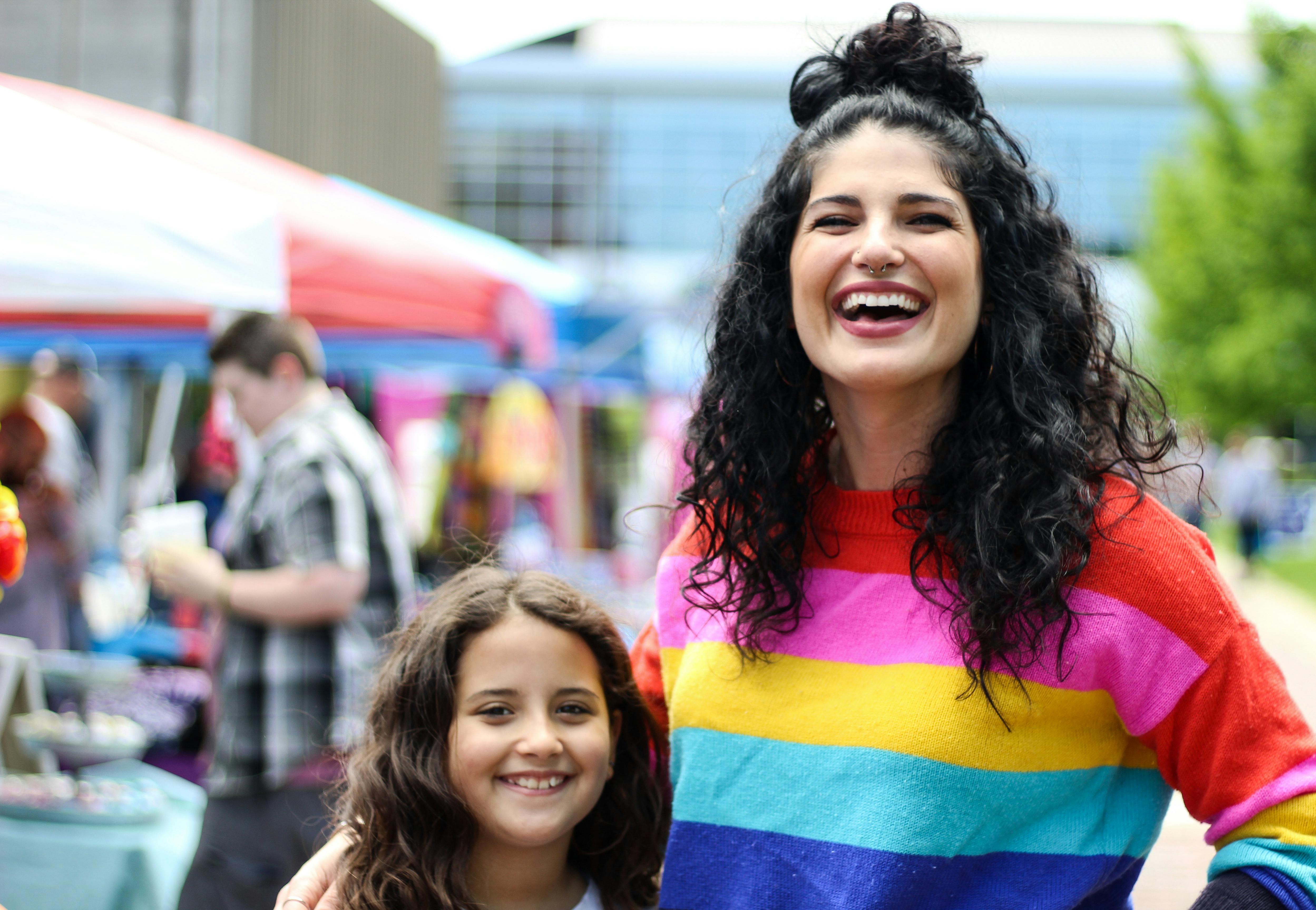 A woman with a child at a street fair.