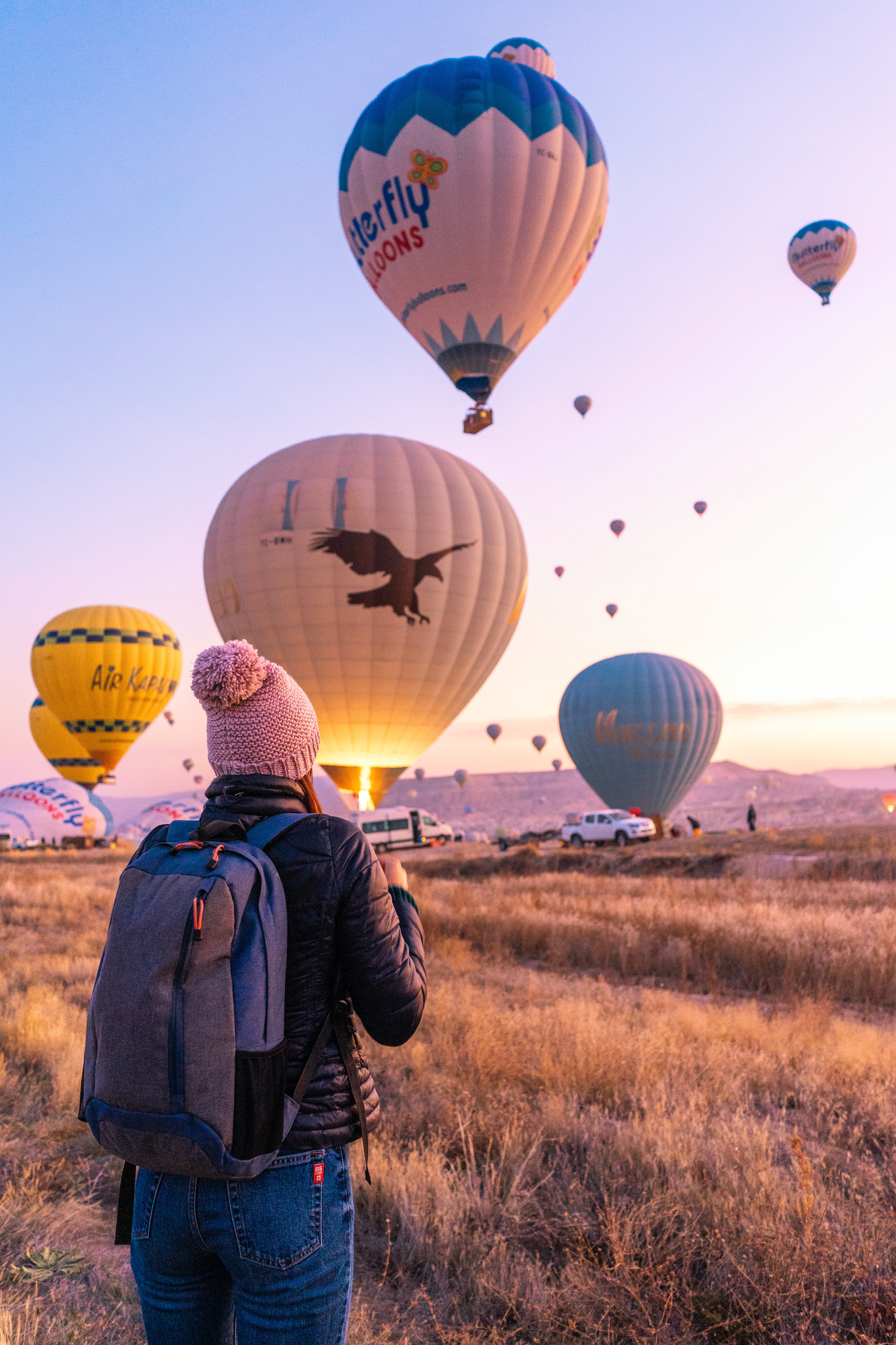 Woman looking at hot air balloons