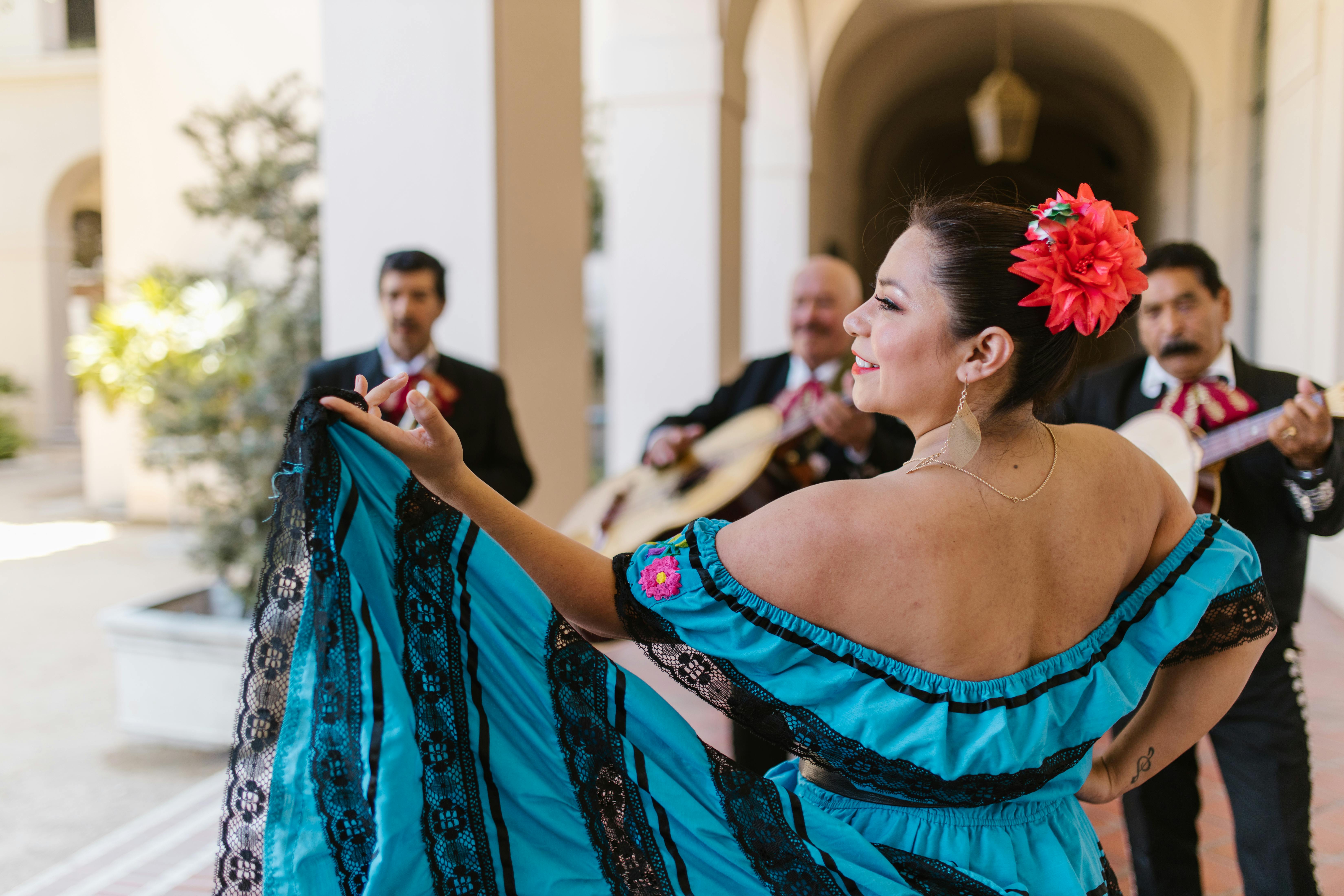Woman dancing with a Mariachi band.