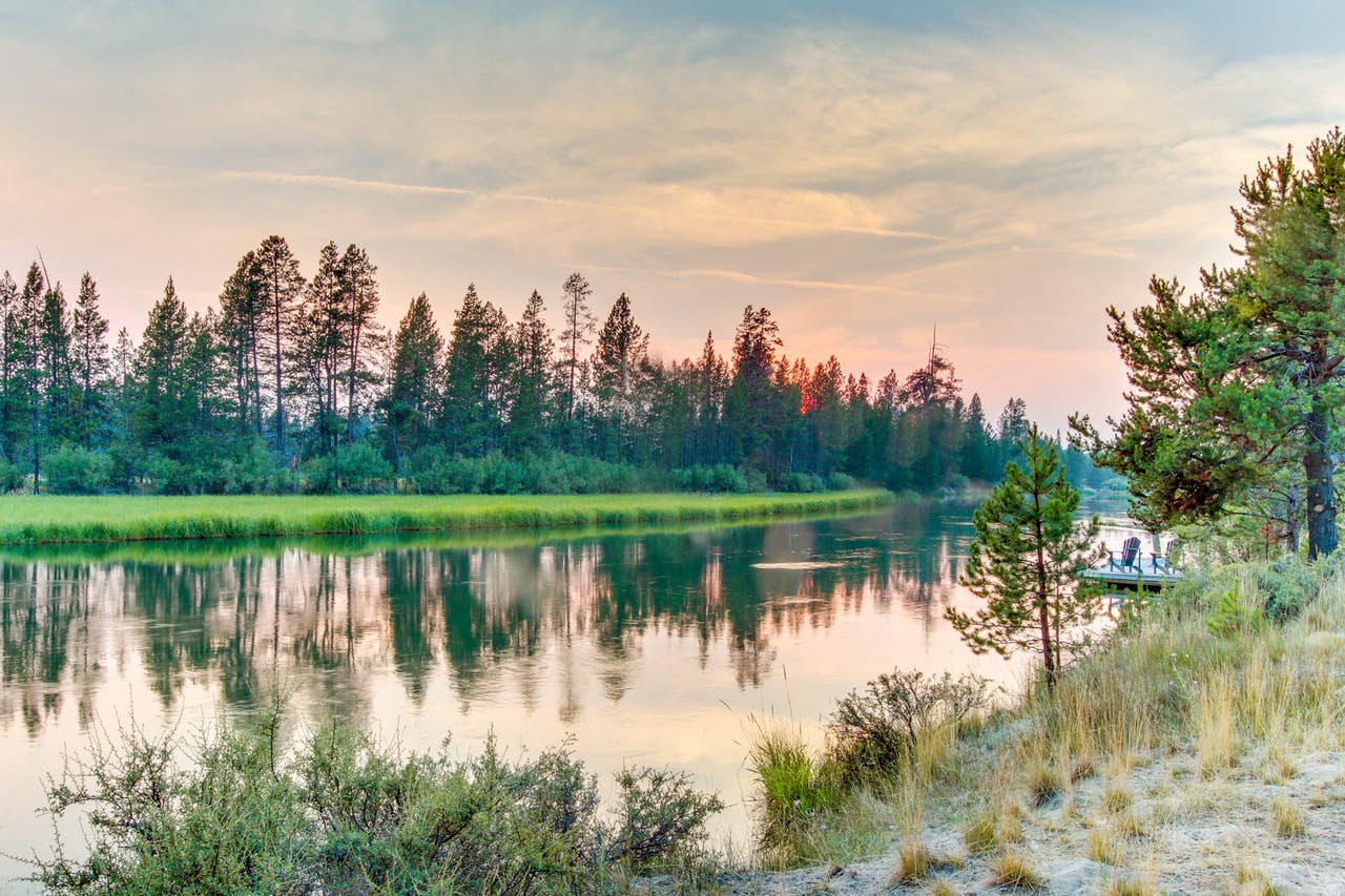 The deschutes river near sunriver with the sun setting in the background