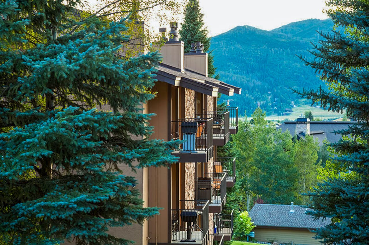 Condominium complex with patios and a view of the mountains in Steamboat Springs, CO