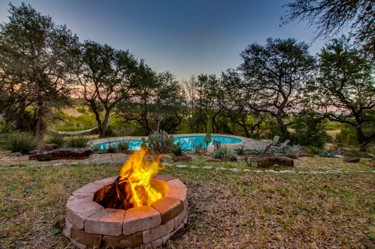 Gorgeous backyard of Dripping Springs vacation rental with firepit and pool