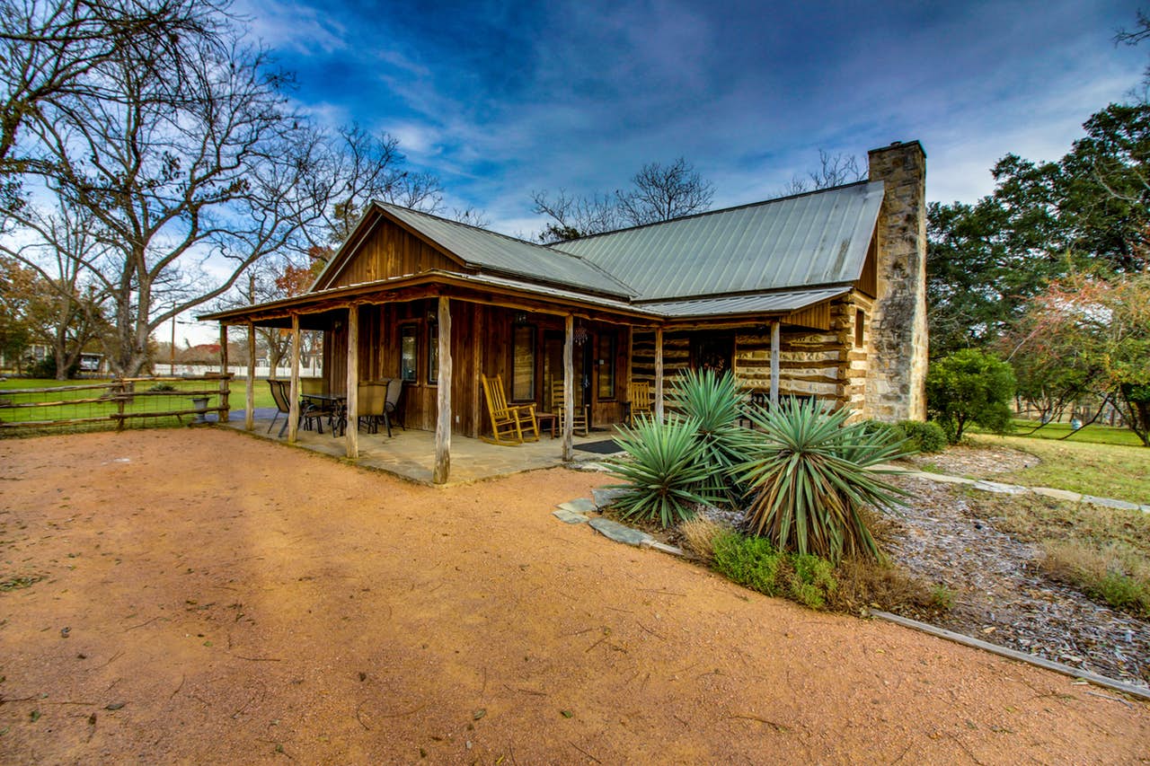 Exterior of cabin with ample front porch seating located in Fredericksburg, TX