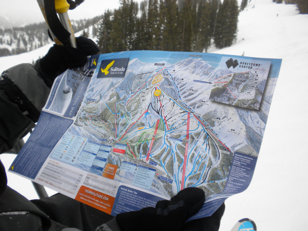 a skier looking at a map of Solitude as they ride the ski lift
