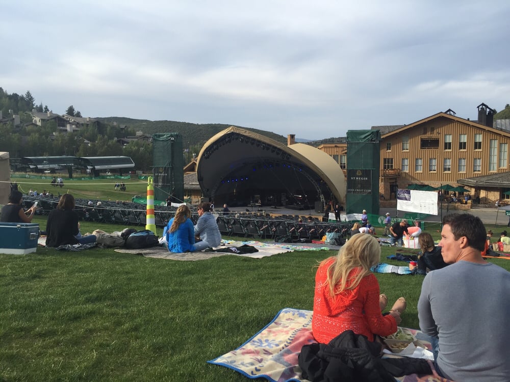 people having a picnic and enjoying a sunny day at Snow Park Outdoor Amphitheater