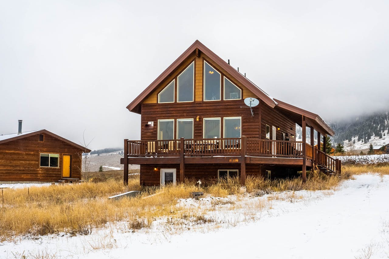 Island Park, ID vacation home with large windows and wraparound deck